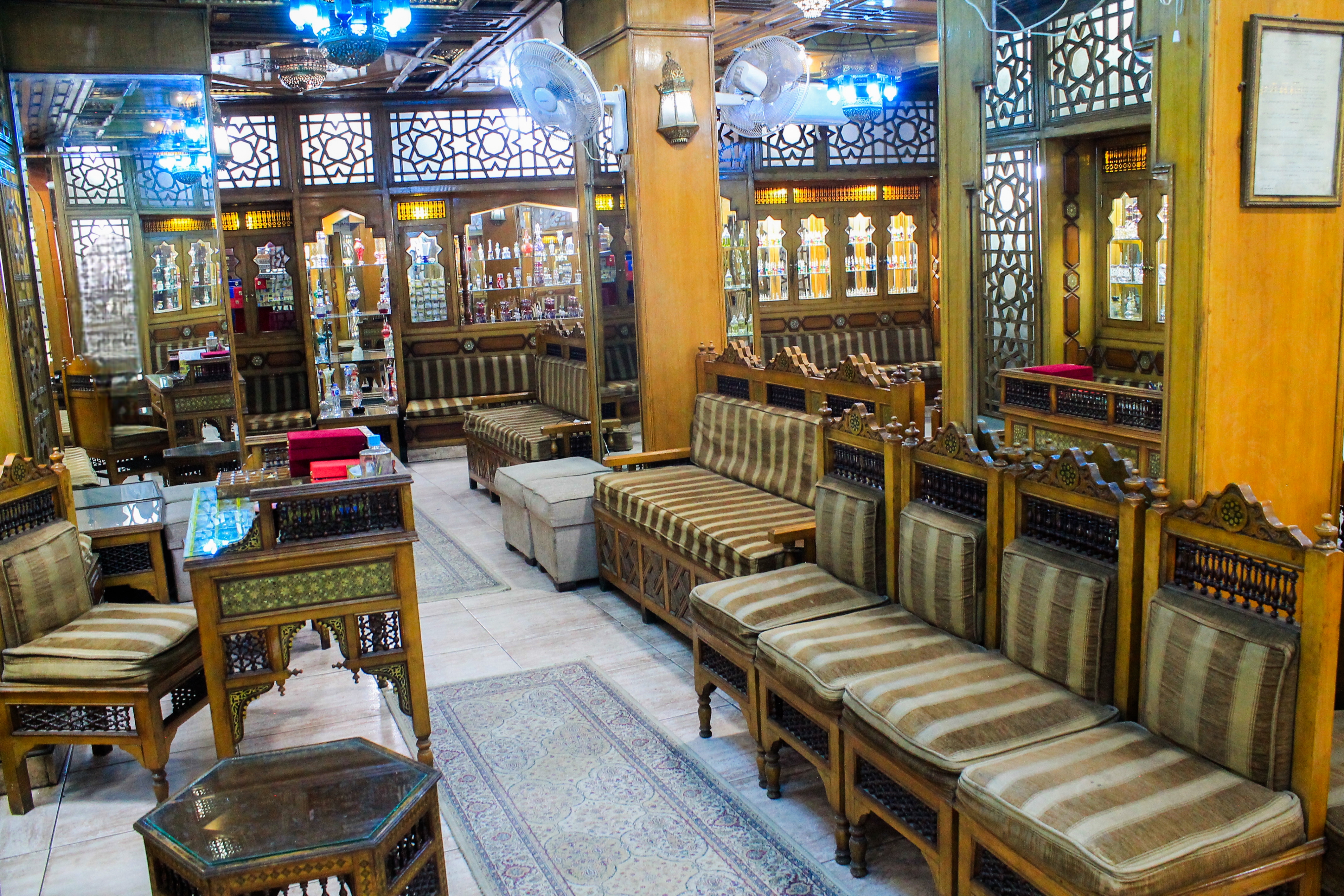 A wide view of the shop sanctuary, where golden lighting meets the warm textures of Egyptian wood.
