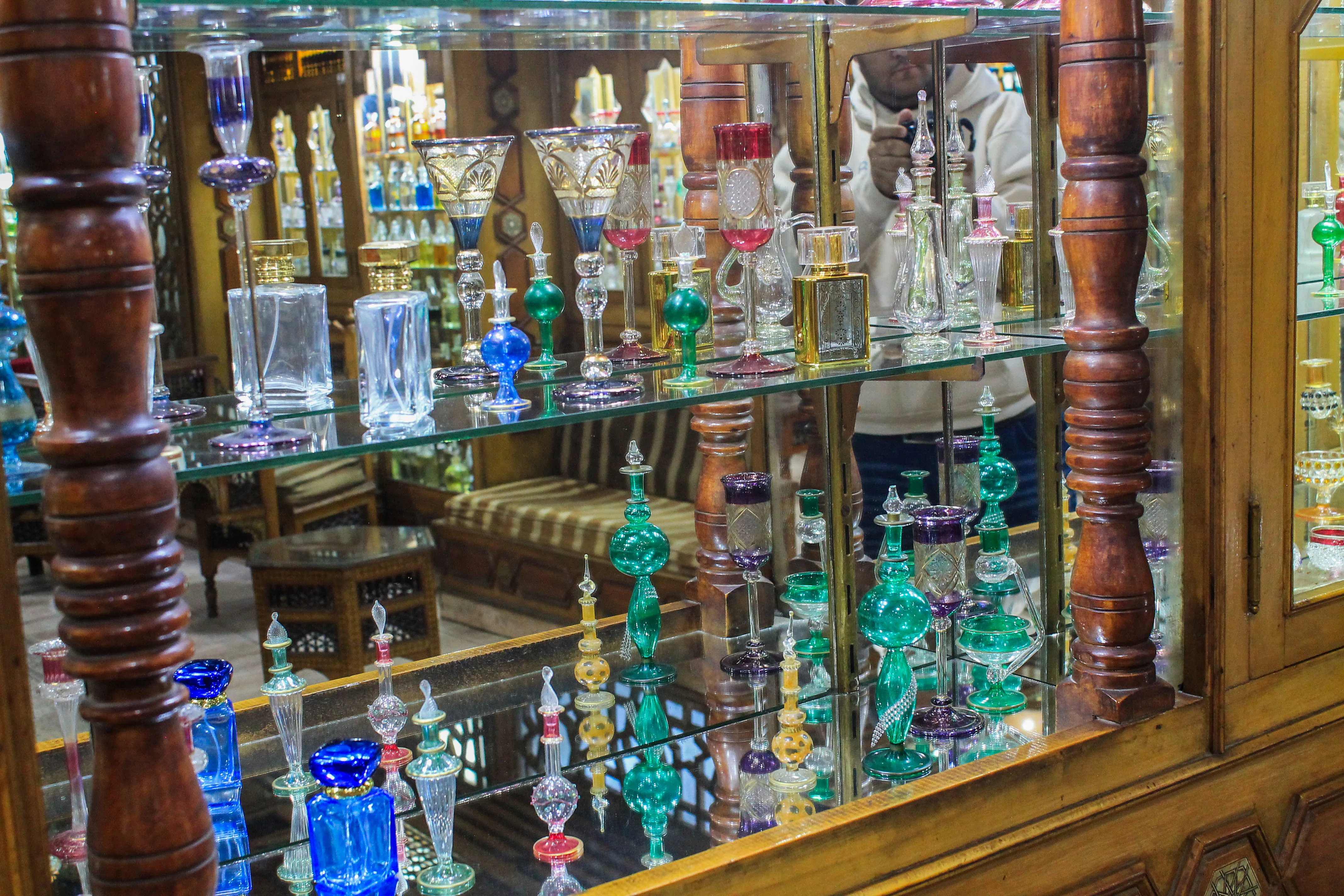 A collection of artistic carved glass perfume bottles, showcasing the intricate detail and geometry of Egyptian glass art.